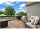Wooden deck with comfortable seating, grill, and railing overlooking the yard and partial view of pool at 9125 Dylan Ridge Ct, Concord, NC 28027