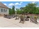Backyard patio with comfortable lounge chairs, fire pit and chairs for relaxing and entertaining at 9125 Dylan Ridge Ct, Concord, NC 28027