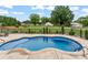 Backyard in-ground pool featuring a concrete deck, black aluminum fence, and a manicured lawn at 9125 Dylan Ridge Ct, Concord, NC 28027