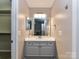 Neutral bathroom with stylish vanity, large mirror, and adequate lighting at 9530 Elizabeth Townes Ln, Charlotte, NC 28277