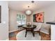 Bright dining area features stylish chandelier, artwork, and window bench seating at 9530 Elizabeth Townes Ln, Charlotte, NC 28277