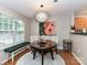 Charming dining area featuring a round table, chandelier, and window bench seating by the window at 9530 Elizabeth Townes Ln, Charlotte, NC 28277