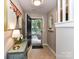 Inviting entryway with tiled floor, artwork, console table with lamp and an open door view of the outside at 9530 Elizabeth Townes Ln, Charlotte, NC 28277