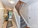 Inviting hallway with a staircase leading to the upper level, with an outside view through the open door at 9530 Elizabeth Townes Ln, Charlotte, NC 28277