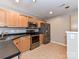 Well-lit kitchen features stainless steel appliances, ample cabinet space, and tiled flooring at 9530 Elizabeth Townes Ln, Charlotte, NC 28277