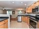 Well-lit kitchen boasts stainless steel appliances and a functional layout with black countertops at 9530 Elizabeth Townes Ln, Charlotte, NC 28277