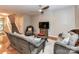 Open-concept living room features a cozy seating arrangement, stairs, and wood-look flooring at 9530 Elizabeth Townes Ln, Charlotte, NC 28277