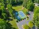 Aerial view of tennis and pickleball courts surrounded by trees and with parking at 9920 White Cascade Dr, Charlotte, NC 28269