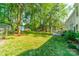 Large grassy backyard with mature trees that give lots of shade, a patio area, and detached storage shed at 9920 White Cascade Dr, Charlotte, NC 28269