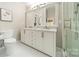 Bright bathroom with a double vanity and glass enclosed shower at 9920 White Cascade Dr, Charlotte, NC 28269
