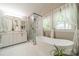 Bright bathroom featuring a soaking tub, glass shower, and double vanity sinks at 9920 White Cascade Dr, Charlotte, NC 28269