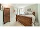 Traditional bedroom with a wooden bed frame, side tables and dresser at 9920 White Cascade Dr, Charlotte, NC 28269