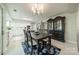 Open-concept dining room with chandelier, table, hutch, that flows into the bright, white kitchen at 9920 White Cascade Dr, Charlotte, NC 28269