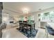 Open-concept dining area features a table, chandelier, and flows into a living room with fireplace at 9920 White Cascade Dr, Charlotte, NC 28269