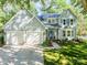 Charming two-story home featuring a two-car garage, manicured lawn, and inviting front porch with classic architectural details at 9920 White Cascade Dr, Charlotte, NC 28269