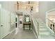 Bright foyer with tile flooring, staircase, and high ceilings showcasing a welcoming entrance and access to the dining room at 9920 White Cascade Dr, Charlotte, NC 28269
