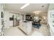 Open-concept kitchen featuring an island cooktop, stainless steel appliances, and seamless flow into the dining and living areas at 9920 White Cascade Dr, Charlotte, NC 28269
