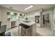 Bright kitchen features white cabinetry, an island with seating, and stainless steel appliances at 9920 White Cascade Dr, Charlotte, NC 28269