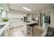 Bright kitchen with white cabinets, stainless steel appliances, island with cooktop, and ample counter space for meal preparation at 9920 White Cascade Dr, Charlotte, NC 28269