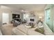 Cozy living room with a white brick fireplace, large sofa, and patterned armchairs at 9920 White Cascade Dr, Charlotte, NC 28269