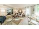 Inviting living room with neutral colors, plush carpeting, large windows, and traditional furnishings, seamlessly connected to dining area at 9920 White Cascade Dr, Charlotte, NC 28269