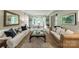 Bright living room with plush carpeting, large windows, and traditional furnishings, creating a comfortable and inviting atmosphere at 9920 White Cascade Dr, Charlotte, NC 28269