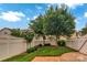 Landscaped backyard enclosed by a white fence, features a stone patio and lush trees at 1006 Phar Lap Dr, Indian Trail, NC 28079