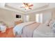 Bright bedroom features tray ceiling, flatscreen tv, and access to bathroom at 1006 Phar Lap Dr, Indian Trail, NC 28079