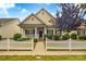 Charming home with a welcoming front porch and manicured landscaping with a picket fence at 1006 Phar Lap Dr, Indian Trail, NC 28079