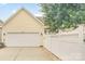 Attached two-car garage with white door and light fixtures, complementing the home's facade at 1006 Phar Lap Dr, Indian Trail, NC 28079