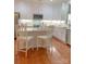 Modern kitchen featuring white cabinets, stainless steel appliances, and hardwood floors at 1006 Phar Lap Dr, Indian Trail, NC 28079