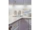 Stylish kitchen counter with white cabinets, decorative tile backsplash, and modern decor at 1006 Phar Lap Dr, Indian Trail, NC 28079