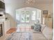 Bright living room boasts white wainscotting, a fireplace and a view to the sunroom at 1006 Phar Lap Dr, Indian Trail, NC 28079