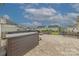Relax in this backyard complete with hot tub, patio, fire pit, picnic table, and manicured lawn at 1048 Harbor Bay Dr, Indian Land, SC 29707