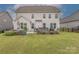 Inviting backyard with a lush lawn, hot tub, and stone patio at 1048 Harbor Bay Dr, Indian Land, SC 29707