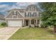Beautiful two-story home featuring a stone-accented facade, well-manicured lawn, and a two-car garage at 1048 Harbor Bay Dr, Indian Land, SC 29707