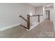 Upstairs hallway features hardwood floors, wood railing, and neutral paint at 1048 Harbor Bay Dr, Indian Land, SC 29707
