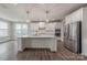 Modern kitchen with large island, stainless steel appliances, and white cabinetry at 1048 Harbor Bay Dr, Indian Land, SC 29707