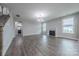 Bright and airy living room features a fireplace, hardwood floors, and large windows at 1048 Harbor Bay Dr, Indian Land, SC 29707