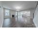 View of a well-lit living room featuring a fireplace and an open floor plan at 1048 Harbor Bay Dr, Indian Land, SC 29707