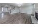 Spacious living room featuring hardwood floors, fireplace, and staircase at 1048 Harbor Bay Dr, Indian Land, SC 29707