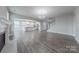 Living room with open layout to a kitchen area featuring hardwood floors and a fireplace at 1048 Harbor Bay Dr, Indian Land, SC 29707