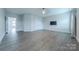 Spacious living room with modern floors, white trim and walls, and a sleek ceiling fan at 1048 Harbor Bay Dr, Indian Land, SC 29707