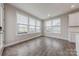 Bright living room features many windows, hardwood floors, and neutral paint at 1048 Harbor Bay Dr, Indian Land, SC 29707