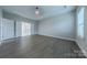 Large bedroom features a tray ceiling and hardwood floors, leading into bathroom at 1048 Harbor Bay Dr, Indian Land, SC 29707