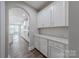 Pantry area with white cabinets, countertop, and access to the main kitchen at 1048 Harbor Bay Dr, Indian Land, SC 29707