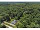 A serene home and detached garage surrounded by a dense, leafy forest, with a private driveway and meticulously maintained landscaping at 10501 Mount Olive Dr # 7, Mount Pleasant, NC 28124