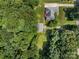 An overhead view of a home and detached garage surrounded by lush greenery on a spacious lot in a wooded area at 10501 Mount Olive Dr # 7, Mount Pleasant, NC 28124