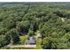 A secluded home and detached garage nestled within a dense forest, offering a private and tranquil setting with ample tree coverage at 10501 Mount Olive Dr # 7, Mount Pleasant, NC 28124