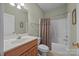 Cozy bathroom featuring a vanity, toilet, and shower-tub combo with a neutral shower curtain at 10501 Mount Olive Dr # 7, Mount Pleasant, NC 28124